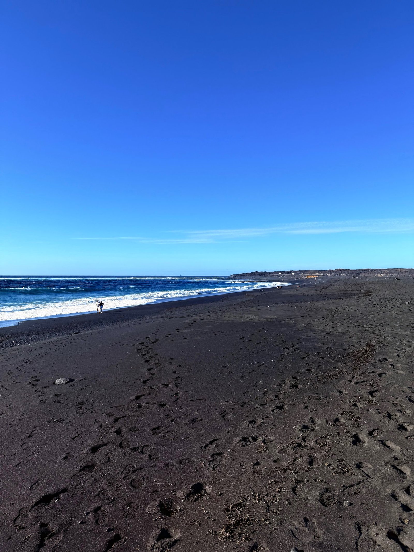 Wide black volcanic beach on the Lanzarote coast