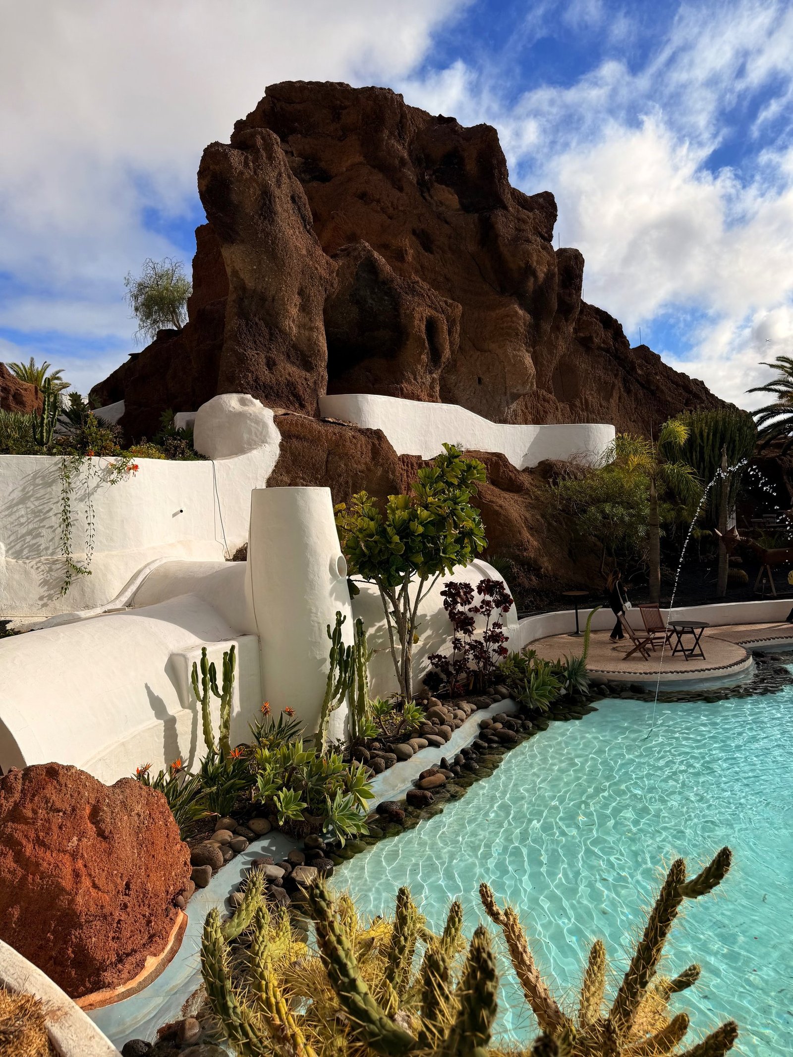 White Lanzarote architecture and pool built around volcanic rock